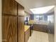 Kitchen features wood cabinets and tile floors at 10828 N Biltmore Dr # 203, Phoenix, AZ 85029