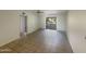 Living room with tiled floor and access to a balcony at 10828 N Biltmore Dr # 203, Phoenix, AZ 85029