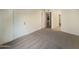Spacious bedroom with a door and view into hallway at 10828 N Biltmore Dr # 203, Phoenix, AZ 85029