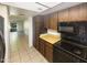 Kitchen with wood cabinets and view of living room at 10828 N Biltmore Dr # 203, Phoenix, AZ 85029