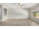 Bright living room with tile floors and ceiling fan at 15631 W Bethesda Ct, Surprise, AZ 85374