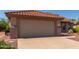 Attached garage with tan walls and terracotta roof at 15631 W Bethesda Ct, Surprise, AZ 85374