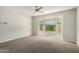 Spacious bedroom with bay window and ceiling fan at 15631 W Bethesda Ct, Surprise, AZ 85374