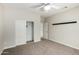 Bedroom with ceiling fan and large closet at 15631 W Bethesda Ct, Surprise, AZ 85374