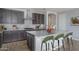 Modern kitchen with a large granite island, stainless steel appliances and dark gray cabinets at 16062 W Alameda Rd, Surprise, AZ 85387