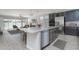 Modern kitchen with granite island, stainless steel appliances, and dark gray cabinetry at 16062 W Alameda Rd, Surprise, AZ 85387