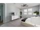 Spacious bedroom with carpeted floor, ceiling fan, and ample natural light at 16062 W Alameda Rd, Surprise, AZ 85387