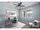 Home office with ceiling fan, desk, chair and large window at 16062 W Alameda Rd, Surprise, AZ 85387