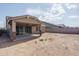 Back exterior view showing a covered patio and landscaping at 16062 W Alameda Rd, Surprise, AZ 85387