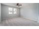 Well-lit bedroom with carpeted floor and ceiling fan at 16062 W Alameda Rd, Surprise, AZ 85387
