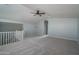 Spacious loft area with vaulted ceilings, carpeted floor, and ceiling fan at 16062 W Alameda Rd, Surprise, AZ 85387
