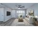 Bright living room with hardwood floors and white couch at 10608 W Edgewood Dr, Sun City, AZ 85351