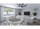 Living room with large window and card table at 10608 W Edgewood Dr, Sun City, AZ 85351