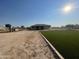 Home exterior and backyard with artificial turf at 12827 S Hermit Rd, Buckeye, AZ 85326