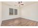 Simple bedroom with wood-look flooring and ceiling fan at 5713 W Rowel Rd, Phoenix, AZ 85083
