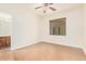 Well-lit bedroom with ceiling fan and access to bathroom at 5713 W Rowel Rd, Phoenix, AZ 85083