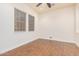 Spacious bedroom with wood-look flooring and two large windows at 5713 W Rowel Rd, Phoenix, AZ 85083