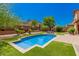 Backyard oasis featuring a sparkling pool and lush landscaping at 5713 W Rowel Rd, Phoenix, AZ 85083