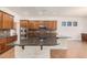Island kitchen with dark countertops and wood cabinets at 5713 W Rowel Rd, Phoenix, AZ 85083