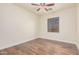 Simple bedroom with wood flooring and large window at 5713 W Rowel Rd, Phoenix, AZ 85083
