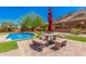 Inviting pool with stone patio and seating area at 5713 W Rowel Rd, Phoenix, AZ 85083