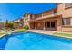 Inviting backyard oasis featuring a sparkling pool, spacious patio, and lush landscaping at 5713 W Rowel Rd, Phoenix, AZ 85083