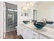 Elegant bathroom with dual sinks and a walk-in shower at 5713 W Rowel Rd, Phoenix, AZ 85083