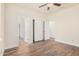 Spacious bedroom with double doors to closet and wood-look flooring at 5713 W Rowel Rd, Phoenix, AZ 85083