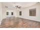 Bonus room with wood-look floors, arched entryway, and multiple windows at 5713 W Rowel Rd, Phoenix, AZ 85083