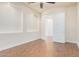 Bright bedroom with wood-look floors and ceiling fan at 5713 W Rowel Rd, Phoenix, AZ 85083