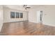 Main bedroom with wood-look floors, large windows, and ensuite bathroom at 5713 W Rowel Rd, Phoenix, AZ 85083