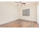 Bright bedroom with ceiling fan and wood-look flooring at 5713 W Rowel Rd, Phoenix, AZ 85083