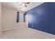 Bedroom with blue accent wall and ceiling fan at 13421 N 151St Dr, Surprise, AZ 85379