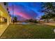 Spacious backyard with a swimming pool and grassy area at 3130 S Valle Verde Cir, Mesa, AZ 85212