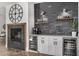 Modern wet bar with stone backsplash, wine cooler, and floating shelves at 3130 S Valle Verde Cir, Mesa, AZ 85212