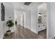 Long hallway with wood-look floors and access to other rooms at 3130 S Valle Verde Cir, Mesa, AZ 85212