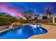 Relaxing kidney-shaped pool with a rock waterfall at 3130 S Valle Verde Cir, Mesa, AZ 85212