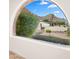 Landscaped front yard with mountain views, visible through an arched window at 7012 N 22Nd St, Phoenix, AZ 85020