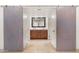 Bathroom with double vanity and barn style doors at 7012 N 22Nd St, Phoenix, AZ 85020