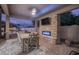 Outdoor patio with a stone fireplace and a dining area at 2223 E Tonto Pl, Chandler, AZ 85249