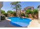 Inviting kidney-shaped pool with waterfall feature, surrounded by a landscaped backyard at 4338 E Foundation St, Gilbert, AZ 85234