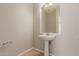 Clean bathroom with pedestal sink and tiled floor at 4338 E Foundation St, Gilbert, AZ 85234