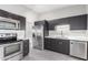 Modern kitchen featuring stainless steel appliances and dark wood cabinetry at 6116 N 12Th Pl # 7, Phoenix, AZ 85014