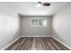 Bright bedroom with wood-look flooring and a window with a view at 6116 N 12Th Pl # 7, Phoenix, AZ 85014