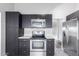 Modern kitchen with stainless steel appliances and dark cabinetry at 6116 N 12Th Pl # 7, Phoenix, AZ 85014