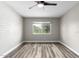 Bright bedroom with wood-look floors and an accent wall at 6116 N 12Th Pl # 7, Phoenix, AZ 85014