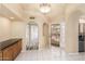 Bright entryway with wood cabinets and tile flooring at 14519 W Trading Post Dr, Sun City West, AZ 85375