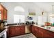 L-shaped kitchen with granite countertops, stainless steel appliances, and wood cabinets at 30317 W Roosevelt St, Buckeye, AZ 85396