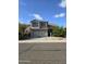 Two-story house with a tan facade, two-car garage, and landscaping at 3856 W Links Dr, Phoenix, AZ 85086