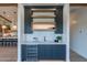 Modern wet bar with dark cabinetry, wine cooler, and quartz countertop at 9633 E Quarter Circle Loop, Gold Canyon, AZ 85118